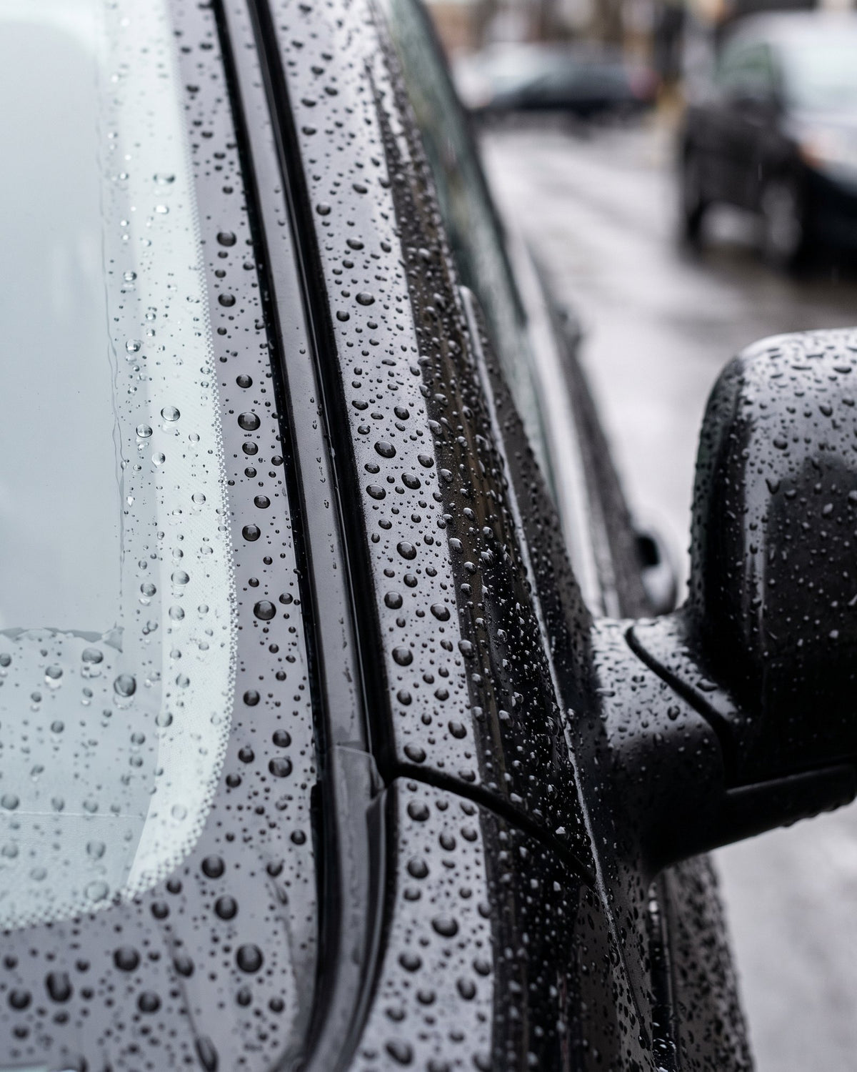 Water beading on glass and black plastic trim