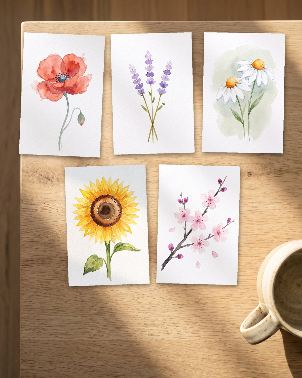 Five painted watercolor postcards in a row: poppy, lavender, daisy, sunflower and cherry blossom